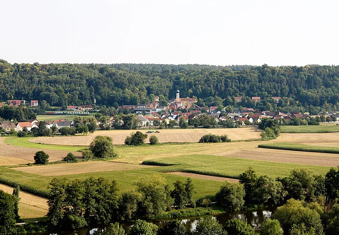 Blick über Felder und Wiesen. Im Hintergrund der Ortsteil Saltendorf mit Marienkirche.
