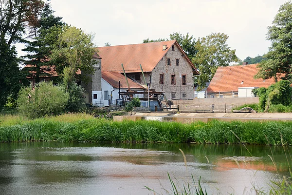 Ein sehr altes Gebäude am Ufer des Flusses Naab, auf direkter Höhe zum Wehr.